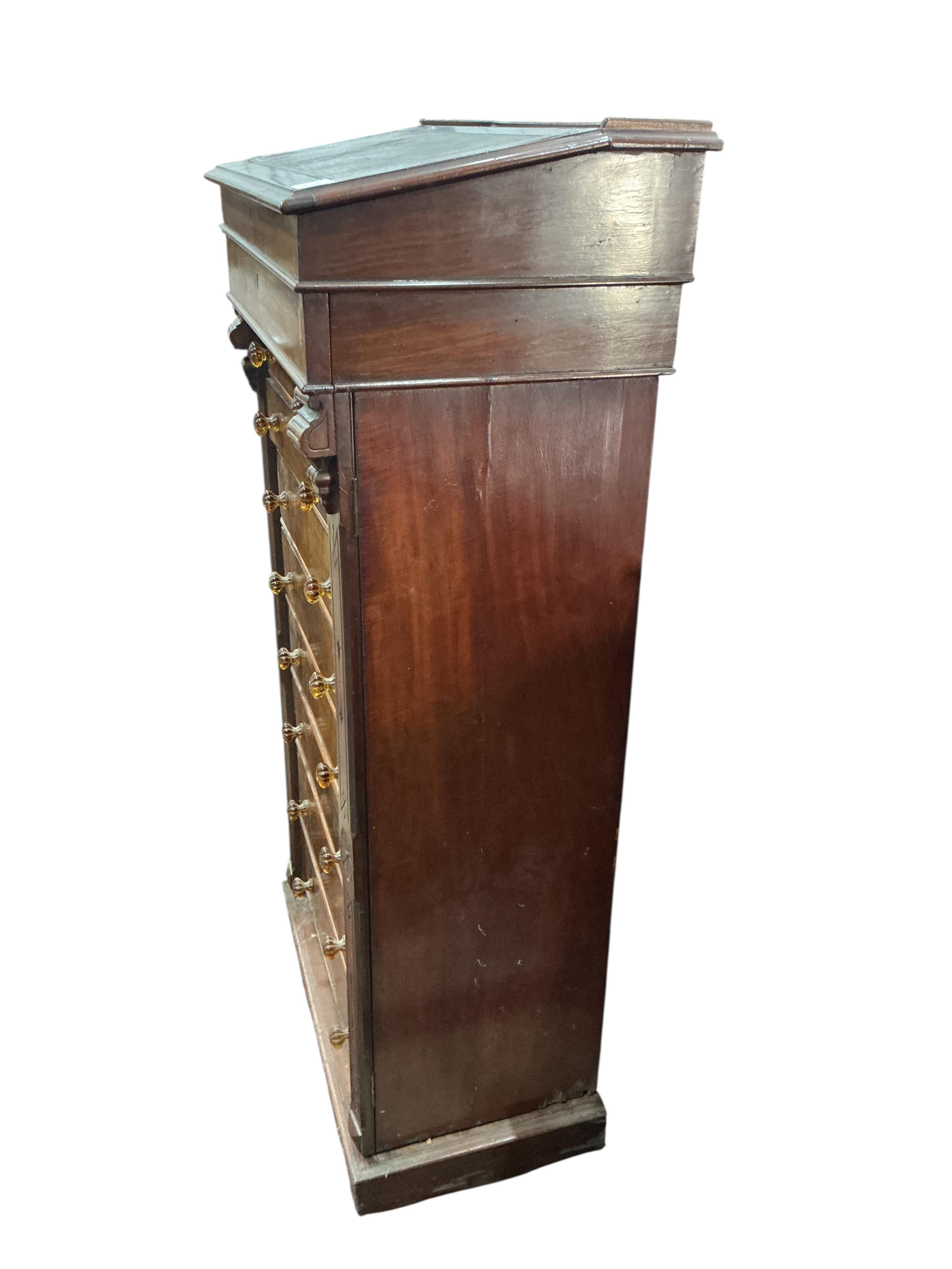 A Victorian mahogany Wellington chest, with writing slope superstructure, width 63cm, depth 40cm, height 130cm